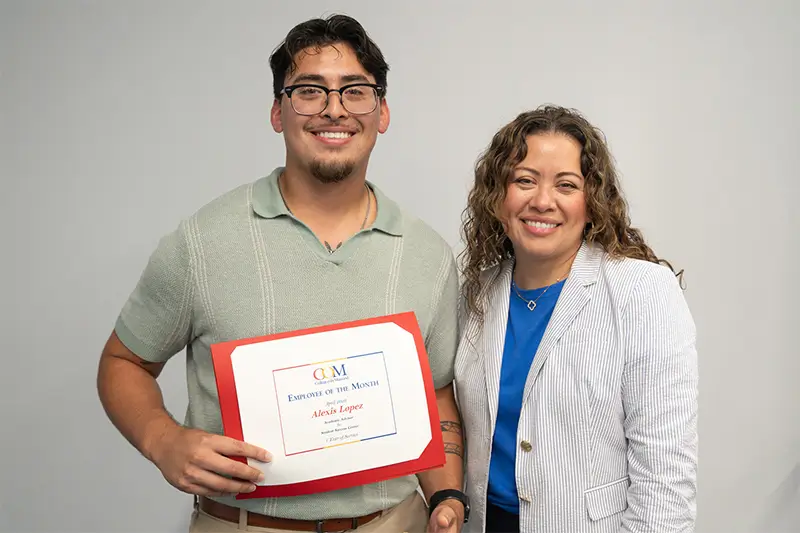 Employee of the Month Alexis Lopez receiving certificate from COM president Dr. Helen Castellanos Brewer