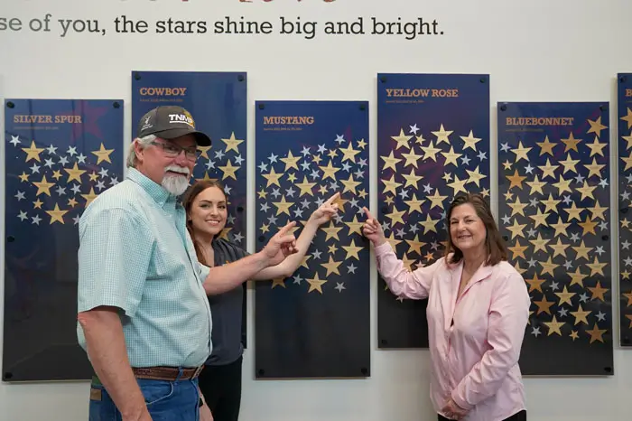 Donors pointing at stars on donor wall.