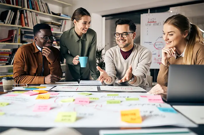 Marketing team meeting at a table.