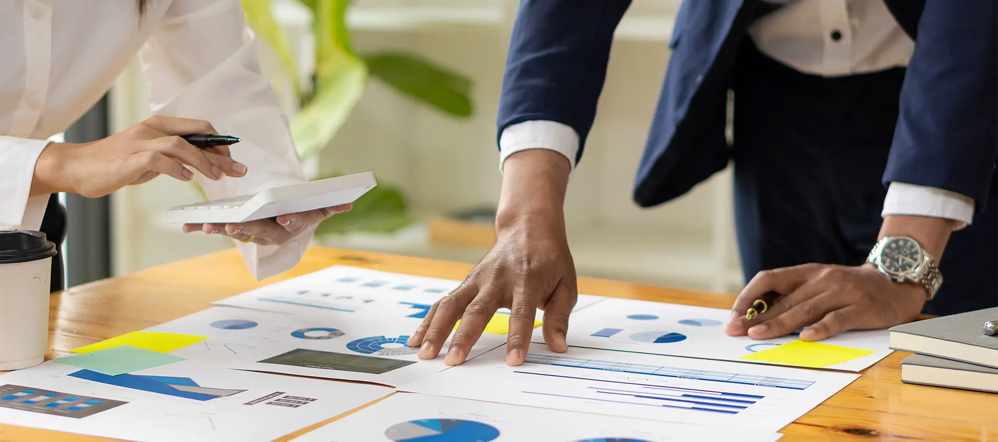 Man and woman at a desk looking at data.