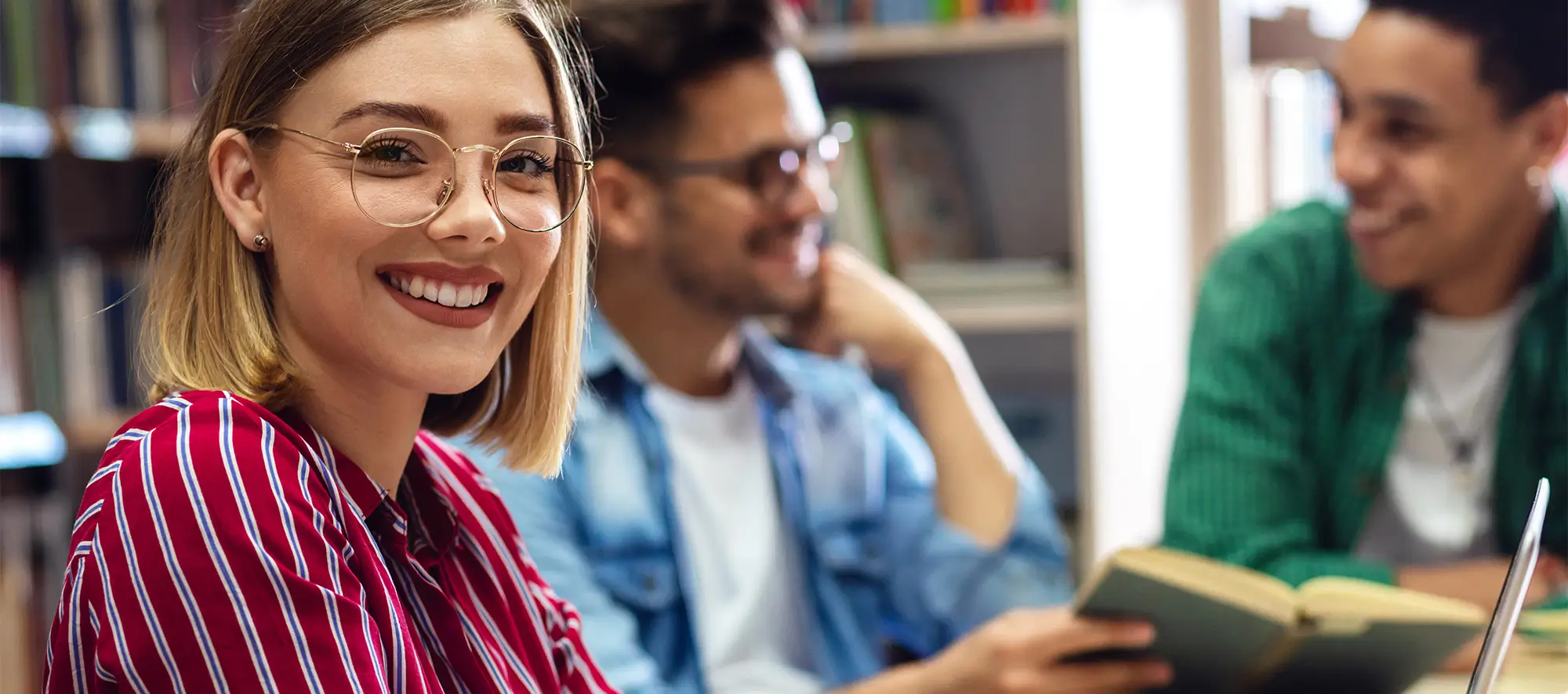 Female student with glasses looking at camera.