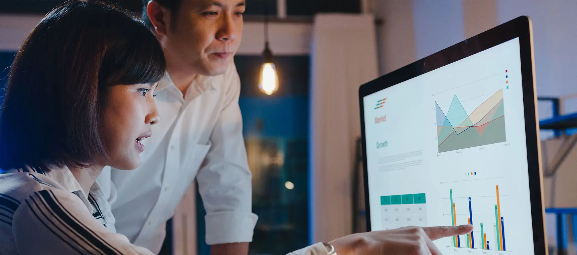 Businessman and businesswoman using computer data presentation.