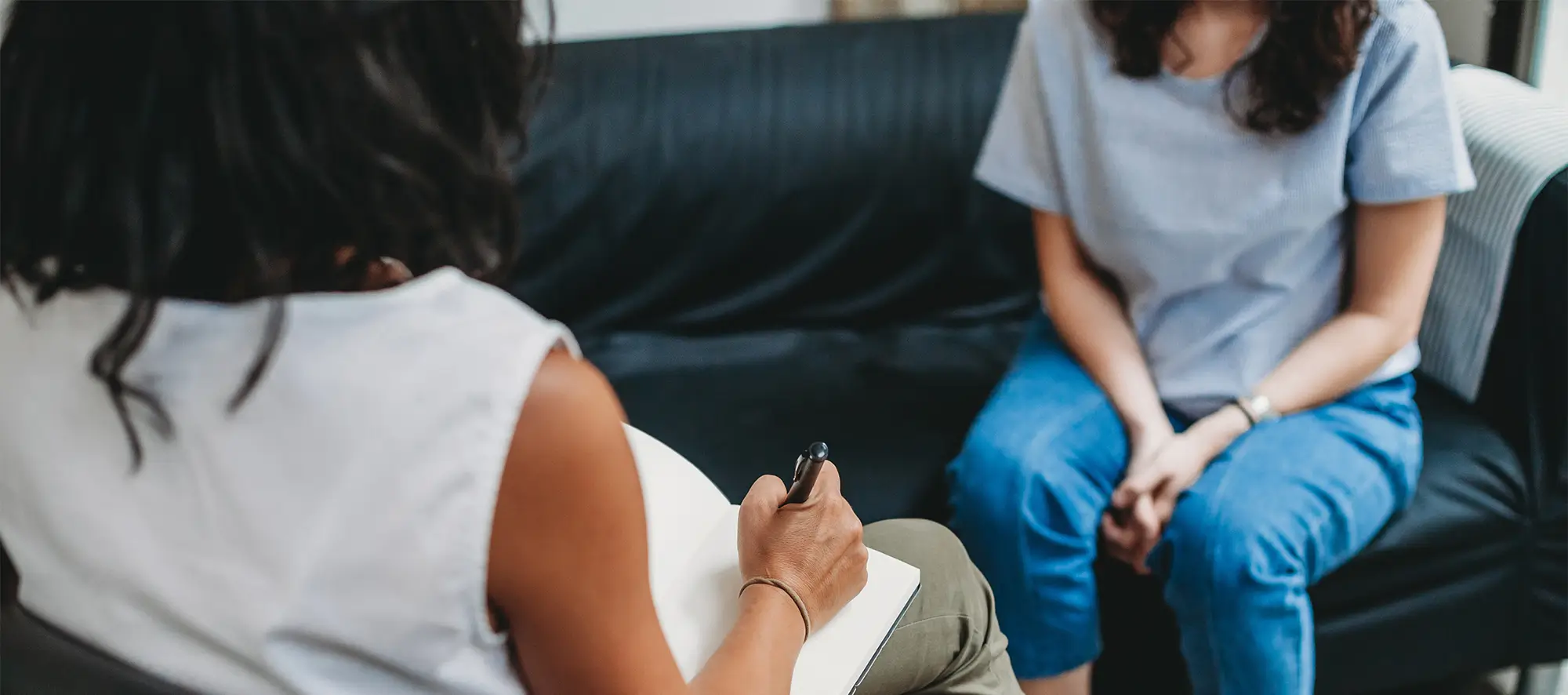 Woman sitting on couch getting counseling.