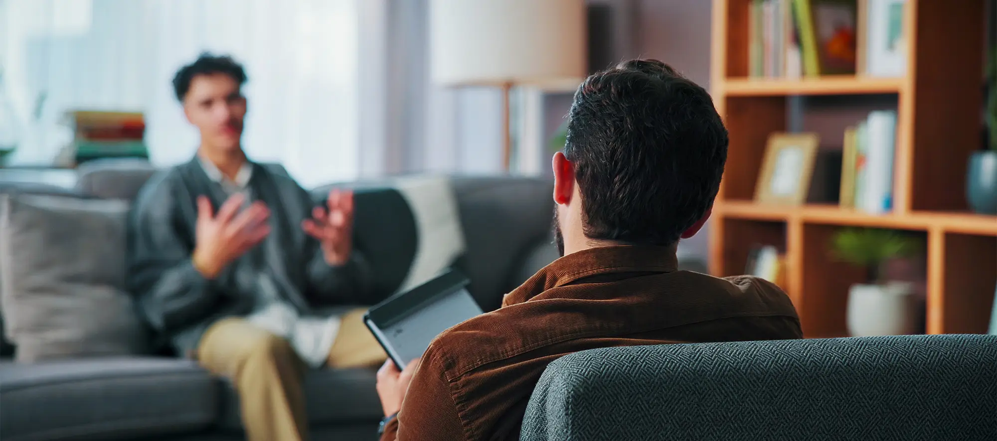 Man sitting on couch receiving counseling.