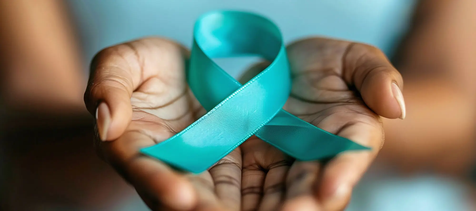 Teal ribbon on womans hand