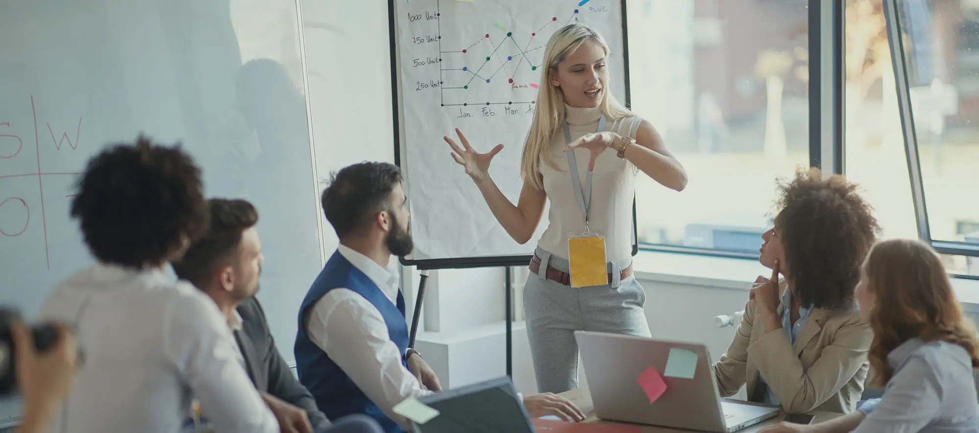 Business woman presents her idea to working team.
