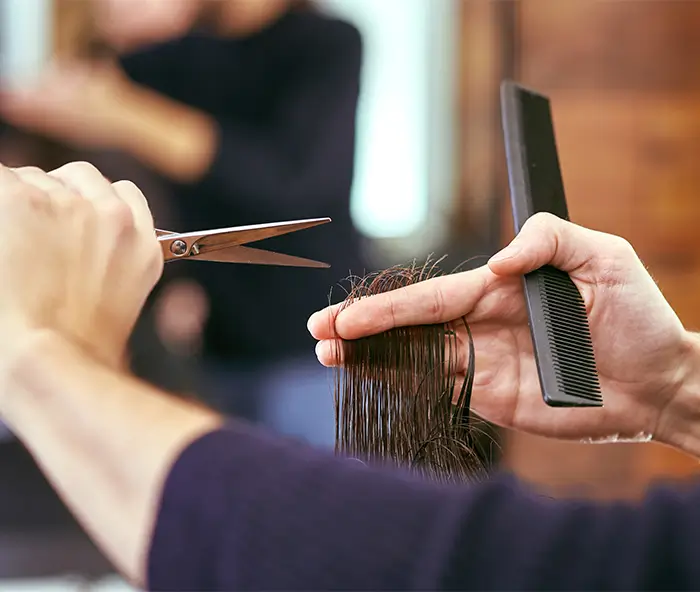 Close up of a person cutting hair.