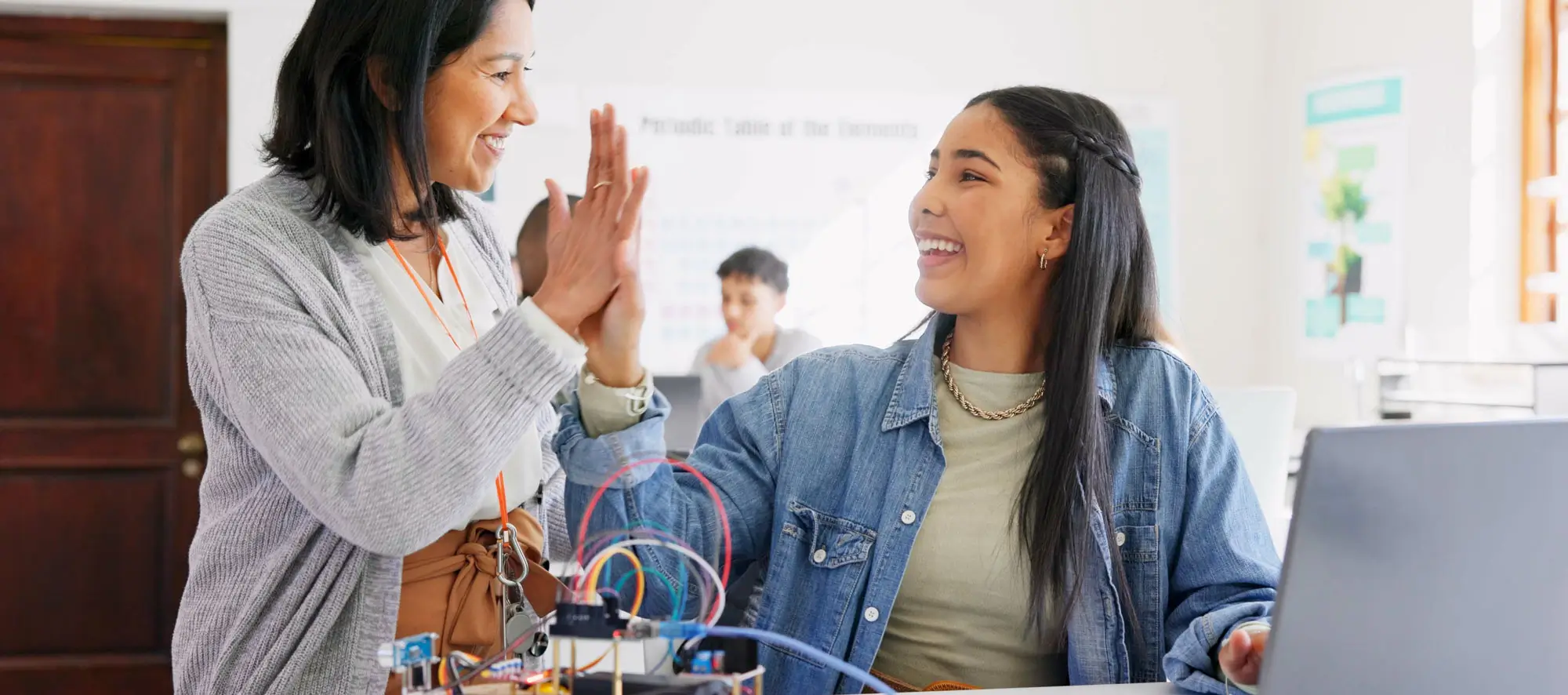 Teacher high-fiving student