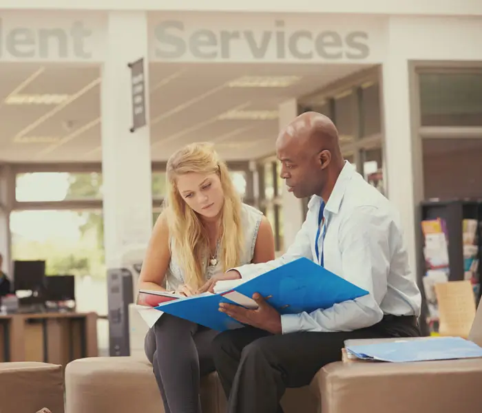 Advisor with student in commons
