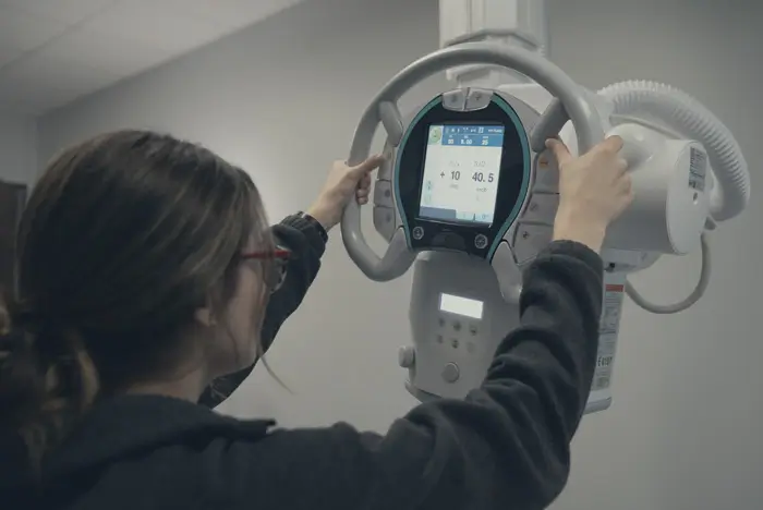 Radiologic Tech student using an X-Ray machine