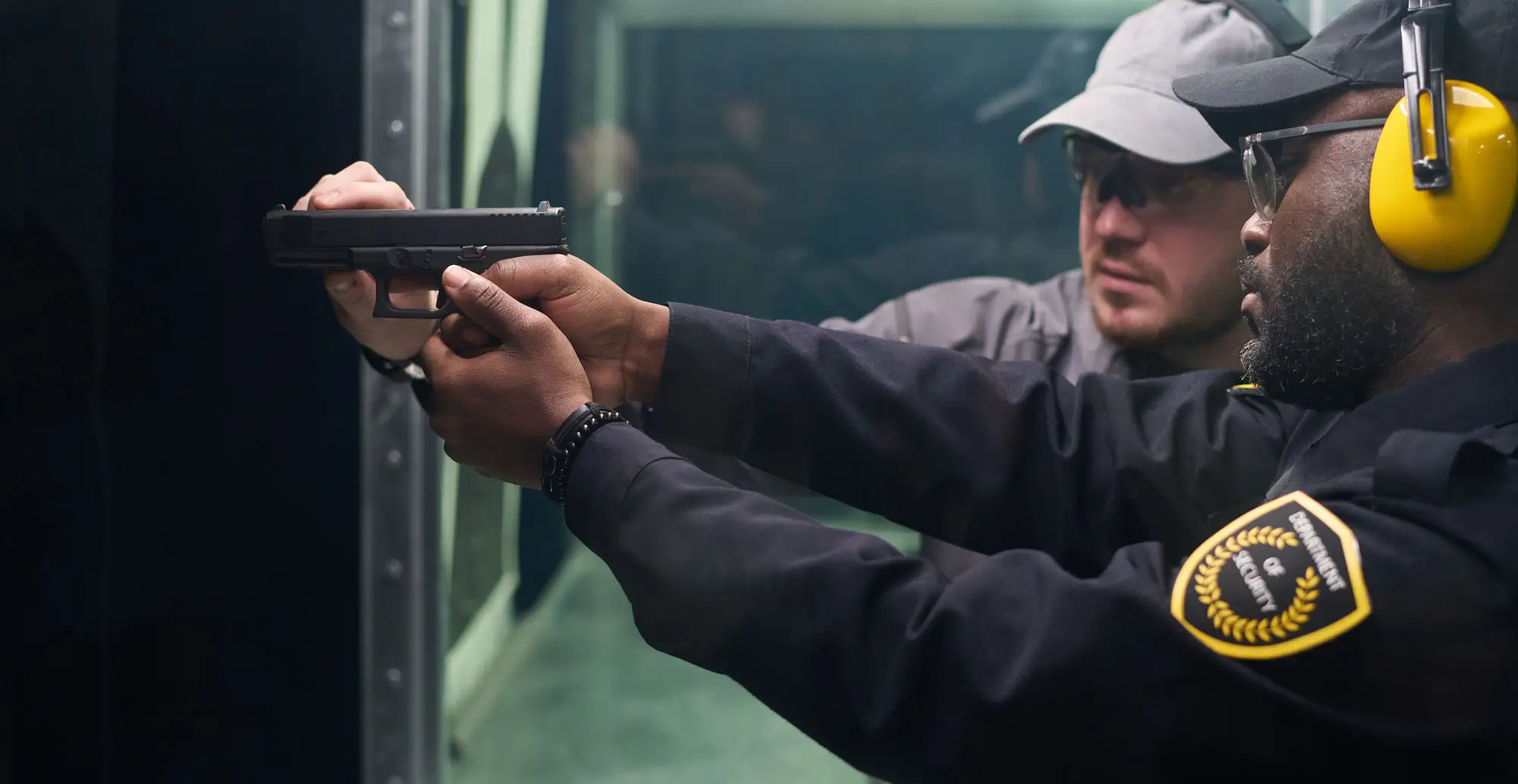 Instructor with police officer shooting a handgun