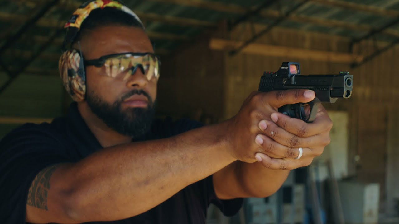 Instructor with fire arm at range shooting