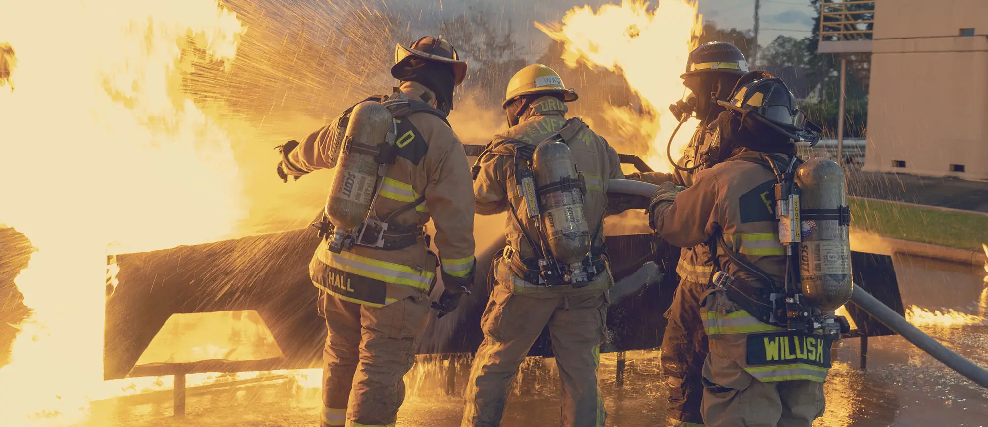 Firefighters putting out a burning car