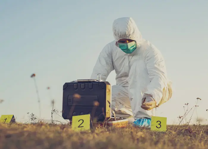 Forensic Investigator in field numbering crime scene