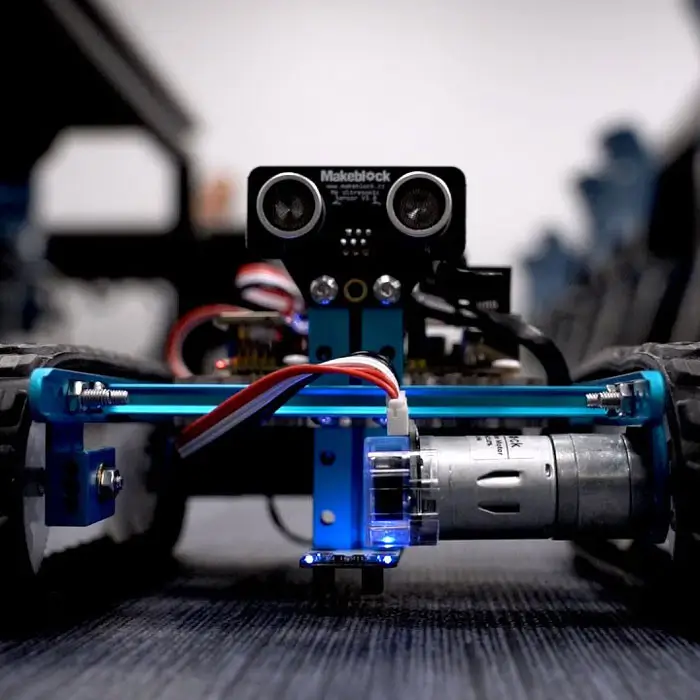 Closeup photo of robotics car on classroom floor.