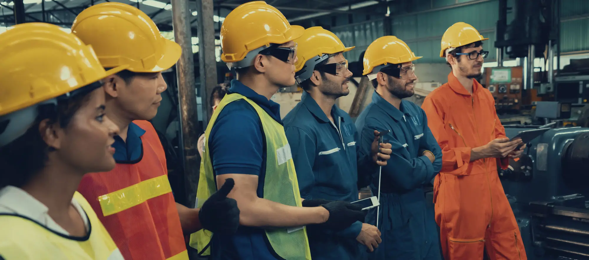 Skillful worker attending brief meeting in the factory.