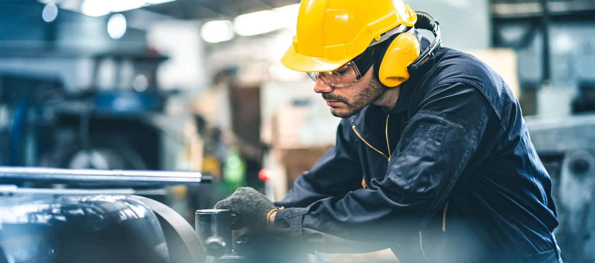 Industrial engineer in hard hat working in an industrial factory.