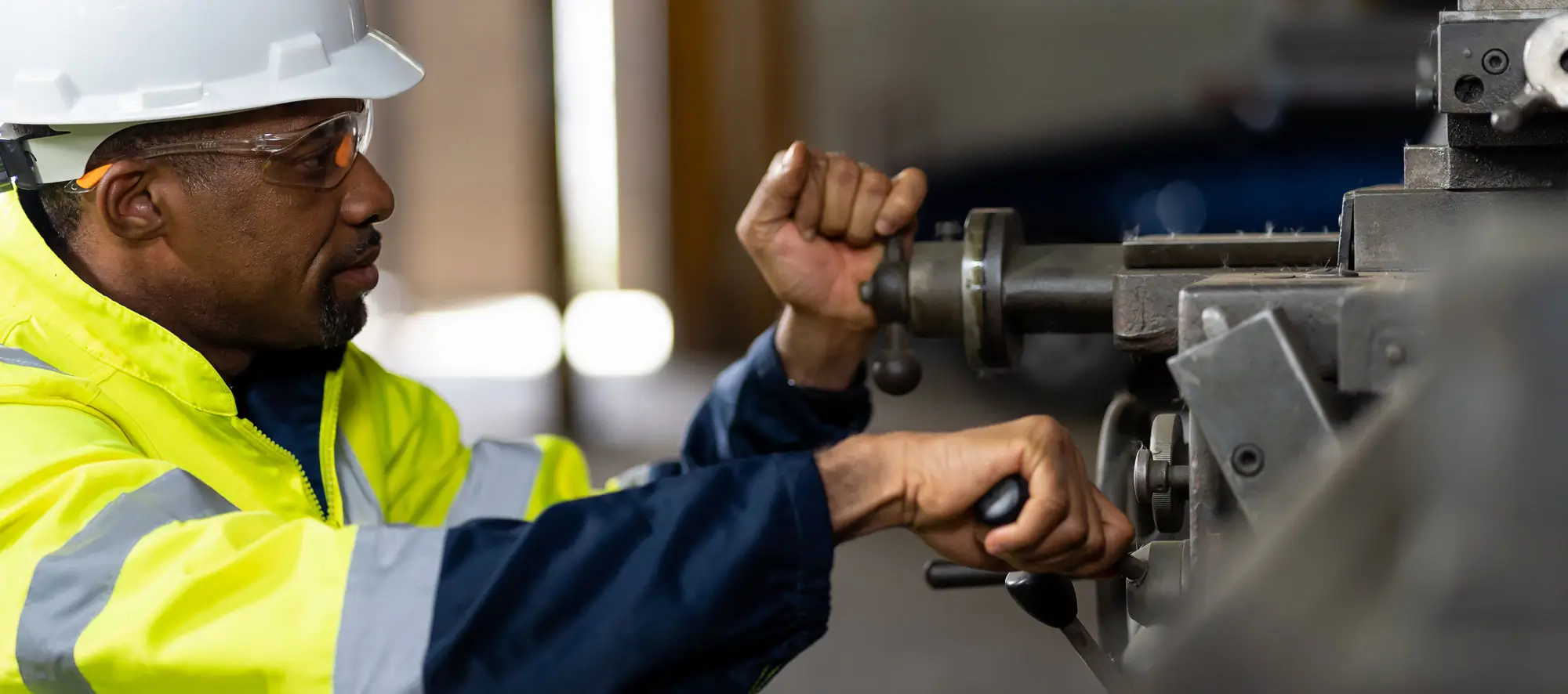 African American male engineer worker maintenance heavy machine in the factory.