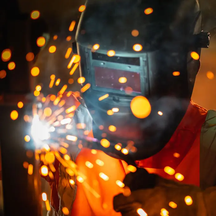 Closeup view of Welder making orange sparks