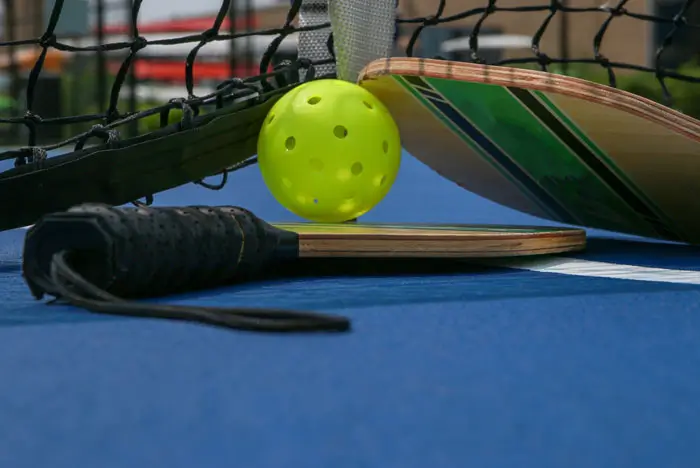 Closeup photo of pickleball rackets and ball