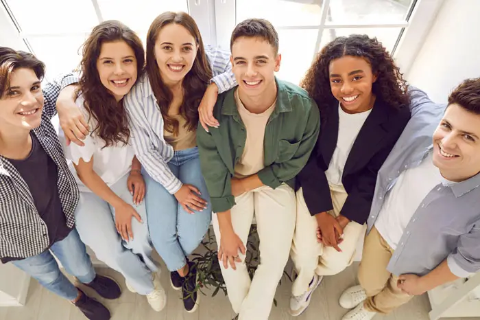 Group of high school kids taking a photo in the hall