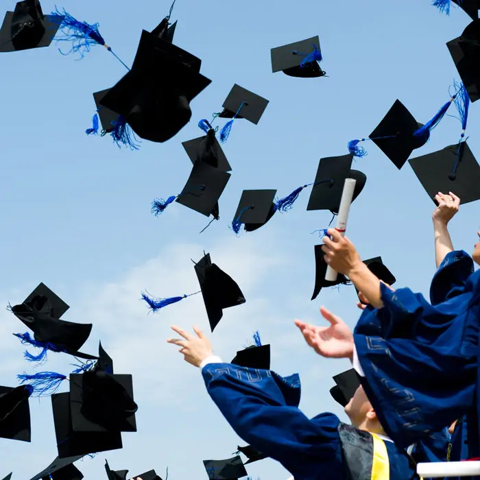 Graduation caps getting thrown into the air