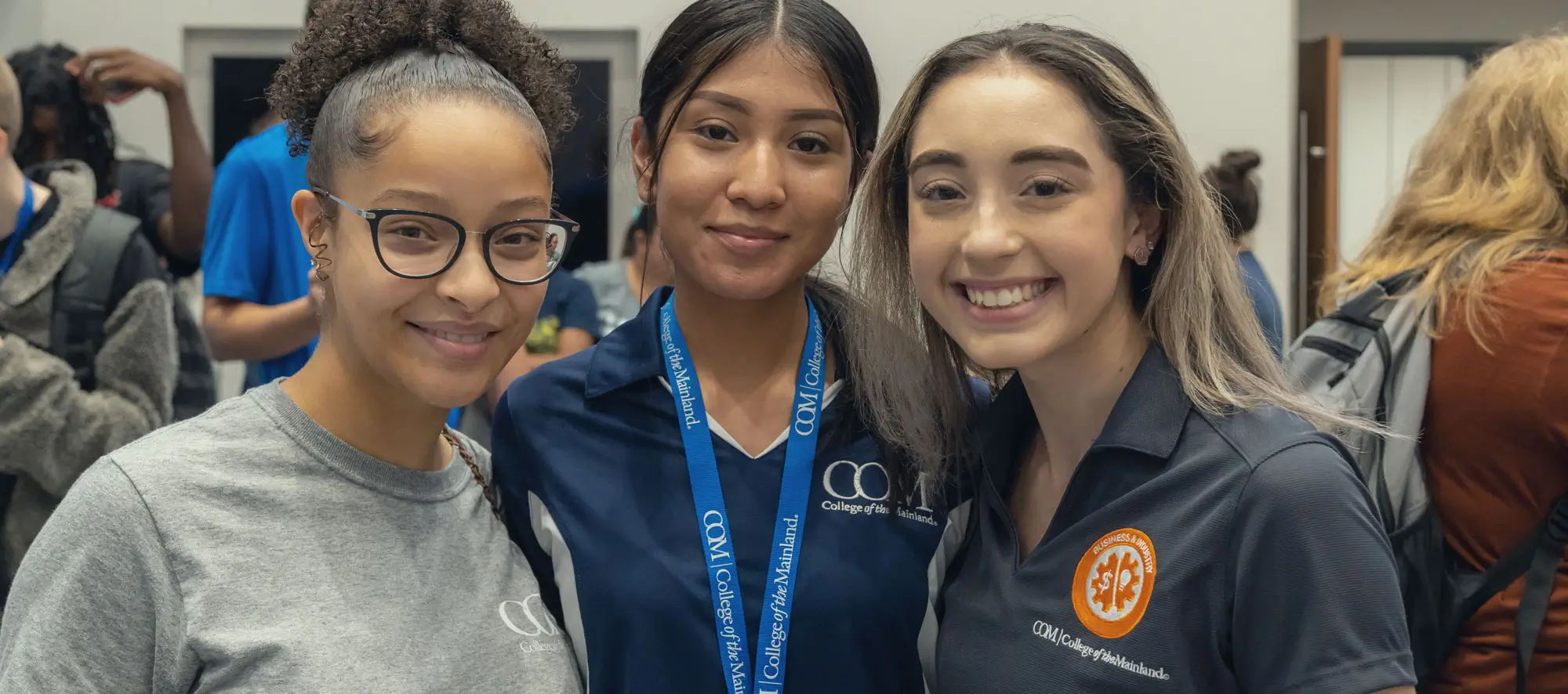 Three young female students at an event.