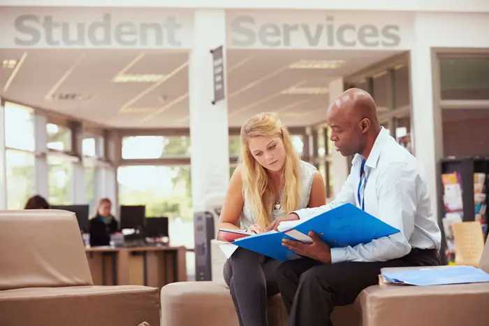 Advisor with student in commons