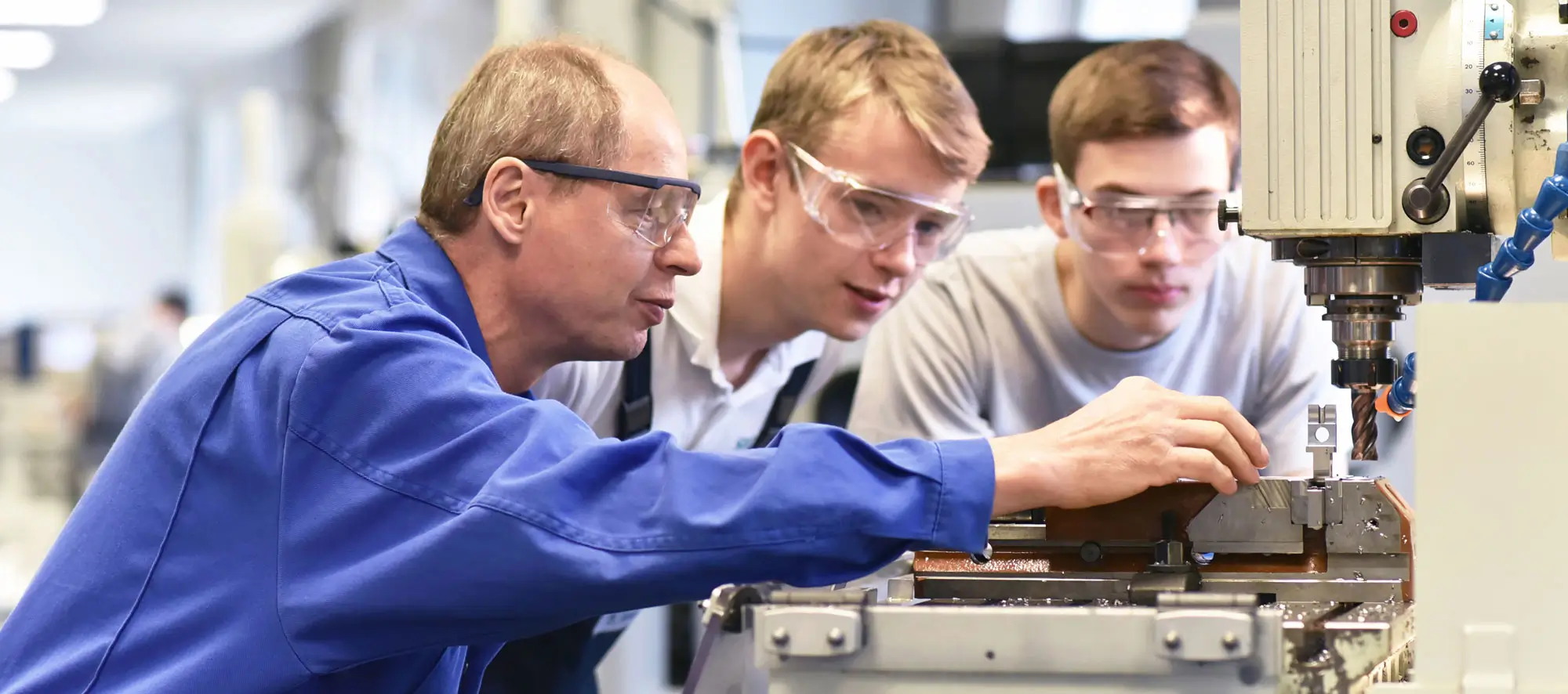 Group of young people in technical vocational training with teacher.
