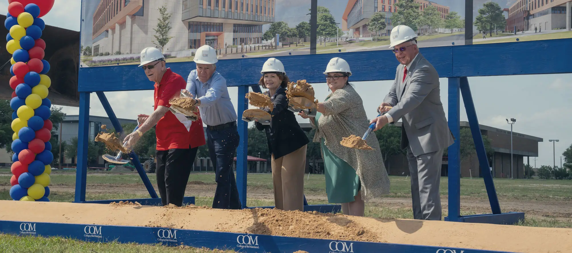 College leadership breaking ground on new site with shovels