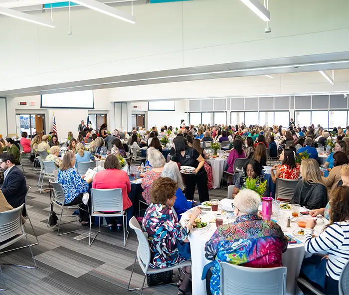 Large group of women in COM conference center.