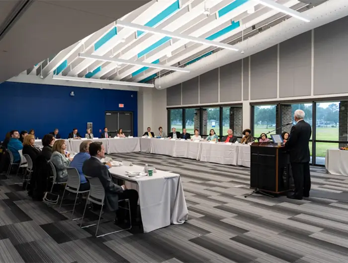 People gathered in conference center breakout room