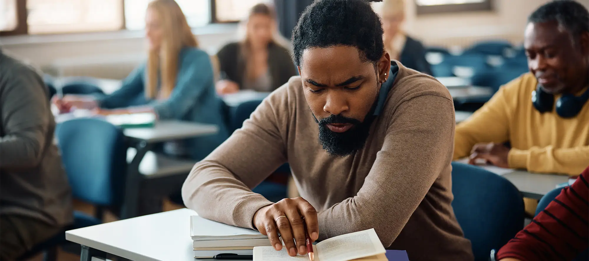 Older man in class studying. 