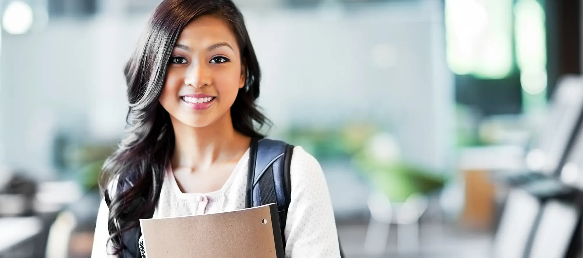 A portrait of an Asian college student on campus.