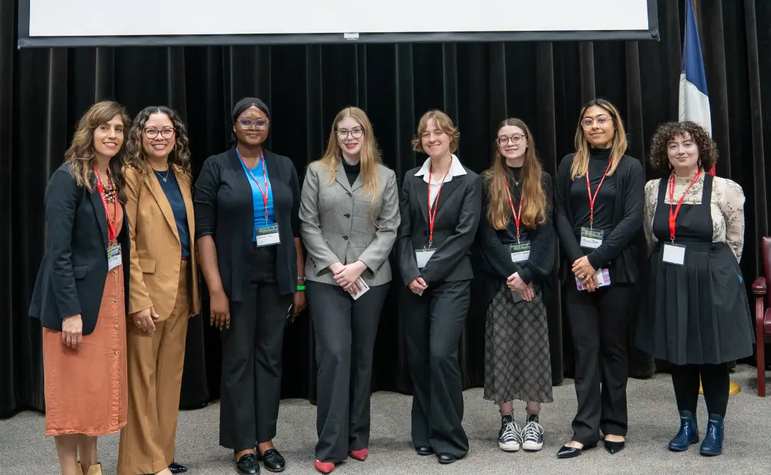 From left: Dalel Serda, COM Professor and GCIC Symposium co-chair; Dr. Helen Brewer, Executive Vice President for Academic and Student Affairs; Temiloluwa Lewis; Nova Dowdell; Maddy Snow; Madison Howell; Maci Allen; Gwendolyn Barbee-yow, COM Professor and GCIC Symposium co-chair.