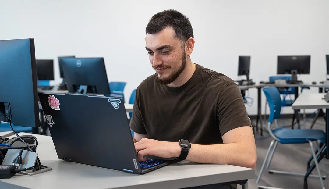RPA Career Training Student Kevin Salazar Typing on his Laptop