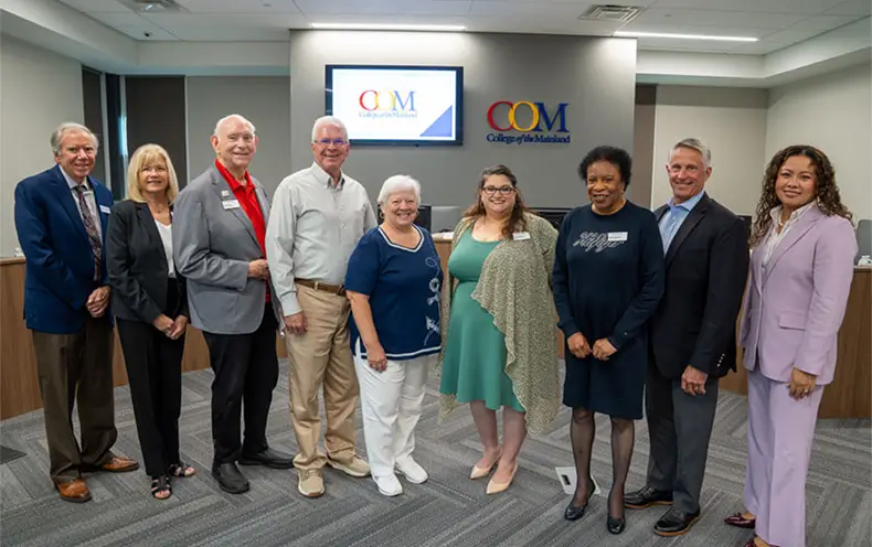 Former COM President Dr. Warren Nichols and his wife, Chris Nichols, stand with the COM Board of Trustees and current president, Dr. Helen Castellanos Brewer.