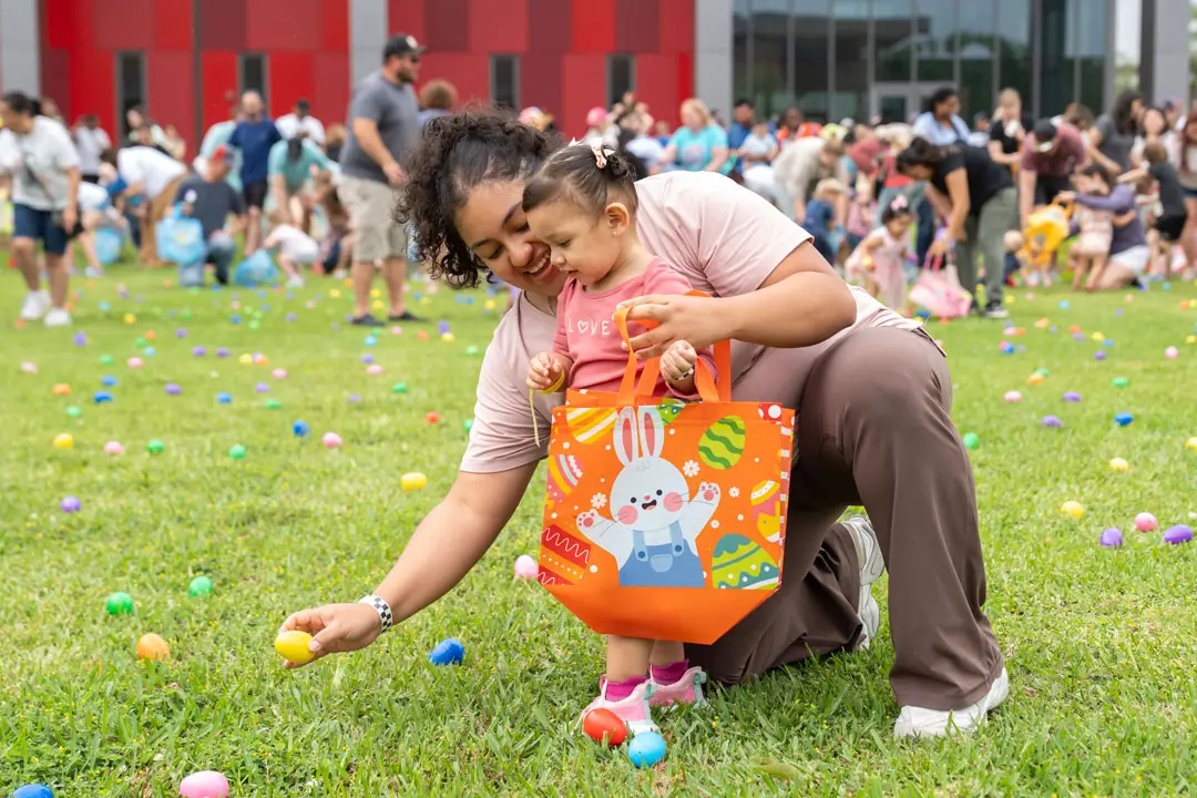 A mother and daughter hunt for Easter eggs during Flock the Block 2025 at College of the Mainland.