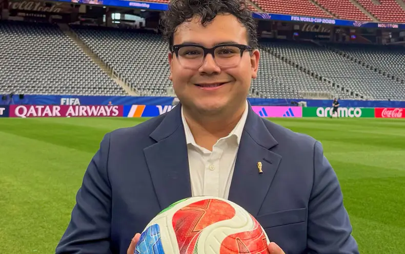 Hayden Victoria on the field at the Houston World Cup Stadium holding a World Cup soccer ball.