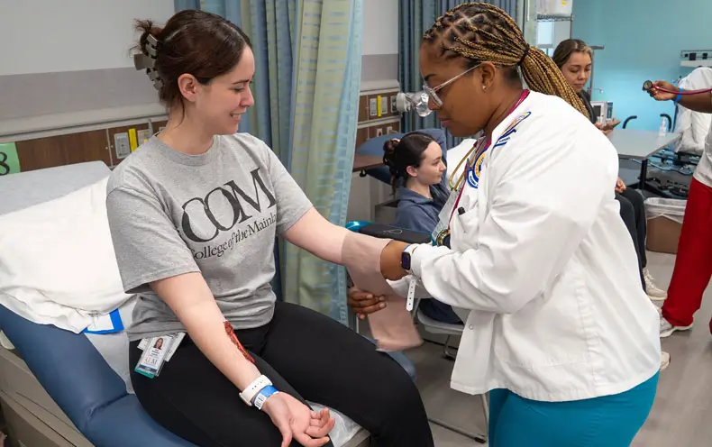 An LVN student bandages up a fellow COM student’s arm during the 2026 Disaster Simulation Day.