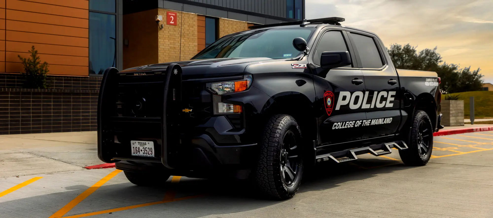 COM Campus Police truck in front of building