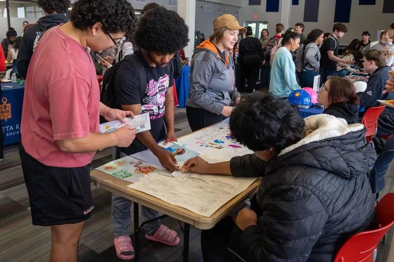 Students signing up for clubs at an event