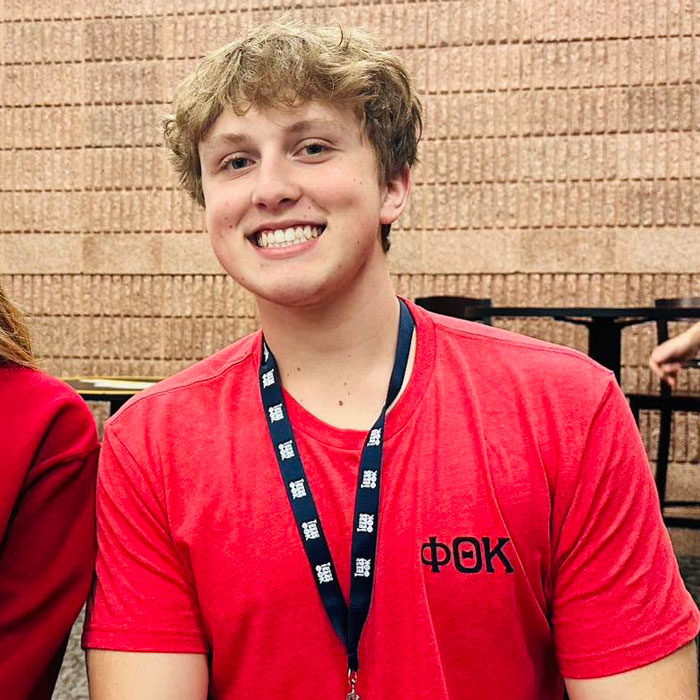 Photo of Kevin Majka in red shirt with medal.