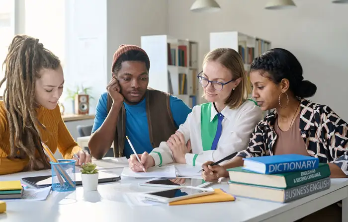 Students at a table working with a tutor